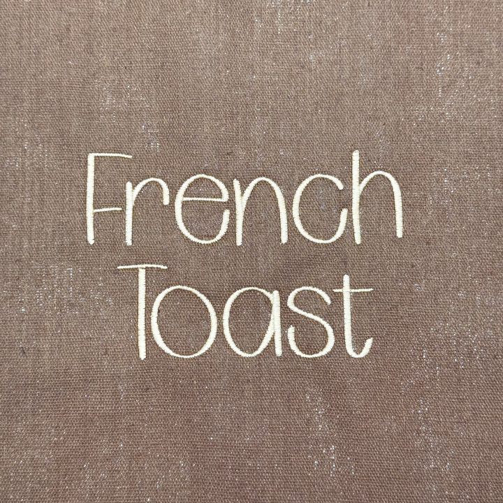 Photograph of stitched out French Toast embroidery font