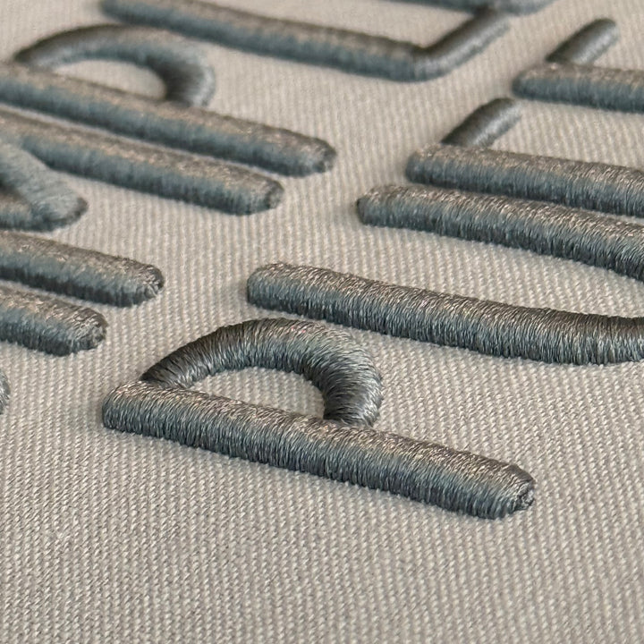 Close up photograph of stitched out Simple Puff embroidery font