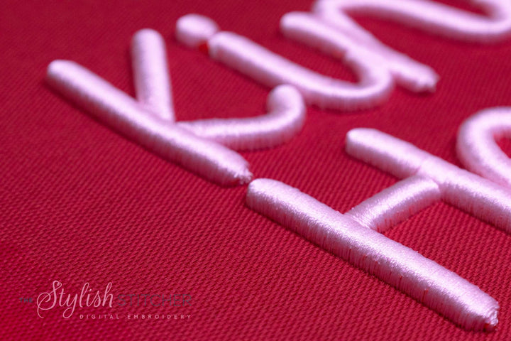 Close up photograph of stitched out Kind Heart 3D embroidery font