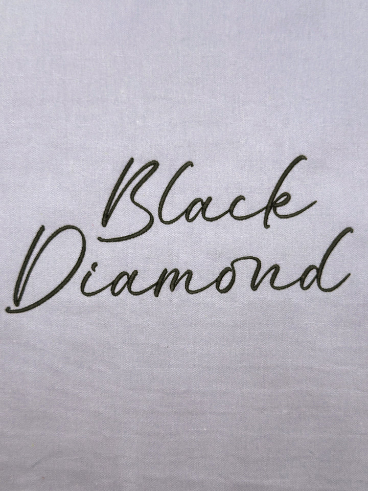 'Black Diamond' embroidered on a light gray fabric background
