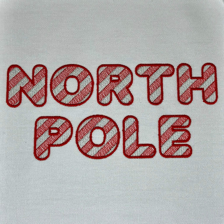Close up photograph of stitched out North Pole embroidery font