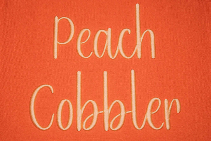 Close up photograph of stitched out Peach Cobbler Puff embroidery font