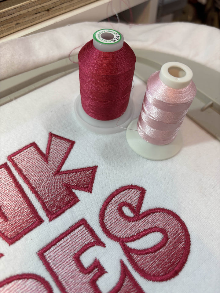 Close up photograph of stitched out Pink Vibes embroidery font
