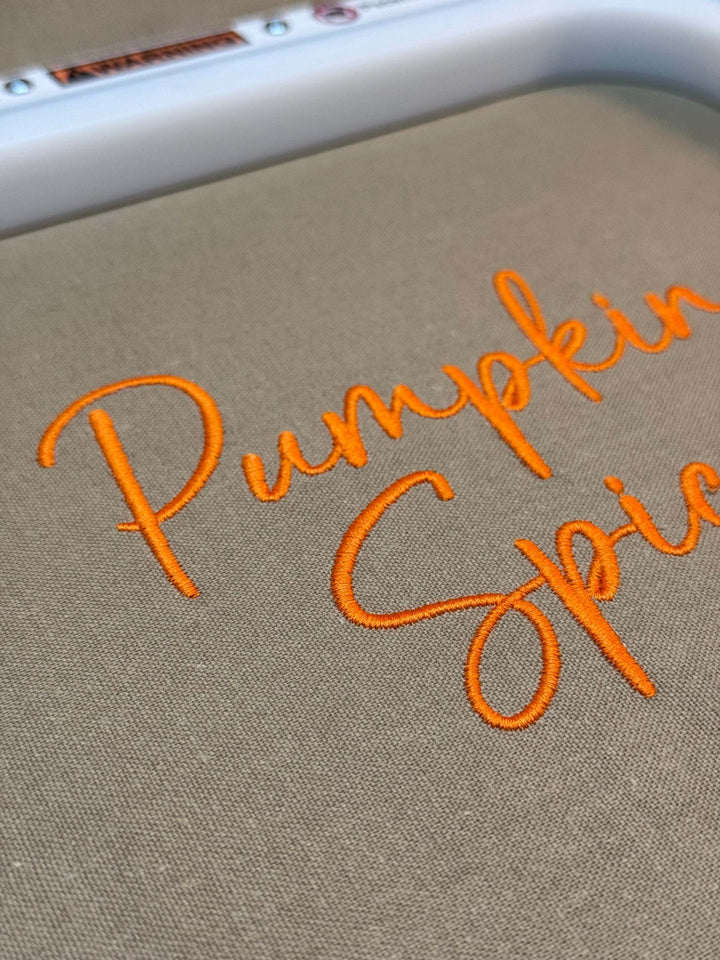 Close up photograph of stitched out Pumpkin Spice embroidery font