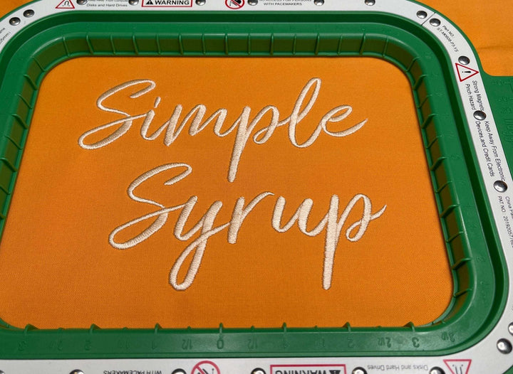 Photograph of stitched out Simple Syrup embroidery font