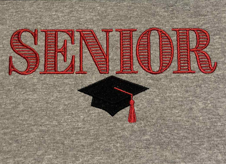 Gray sweatshirt with red 'SENIOR' text using striped serif font and a black graduation cap with red tassel 