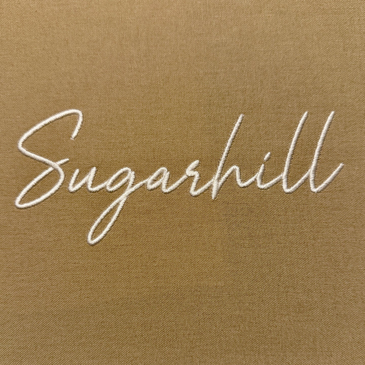 Embroidered 'Sugarhill' text on a beige background