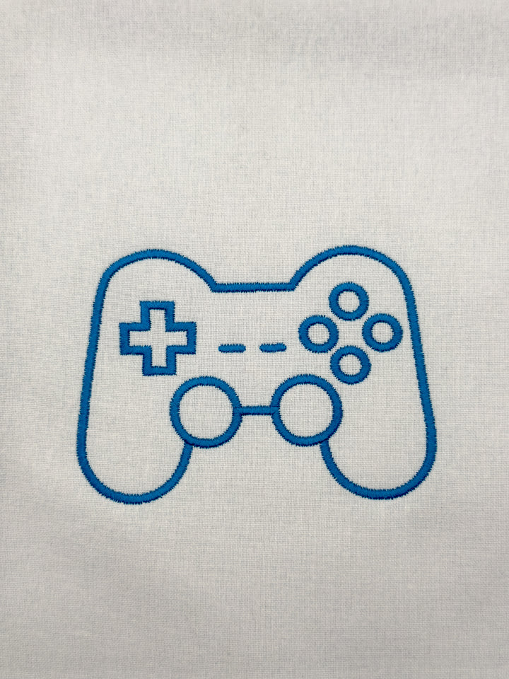 Gaming controller icon embroidery design on a white fabric background