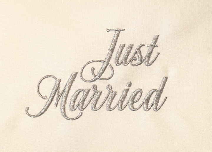 Photograph of stitched out Just Married embroidery font